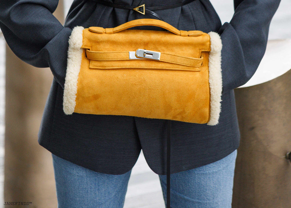Hermès Teddy Kelly Muff in Sable Doblis suede and Mouton shearling with palladium hardware, worn as a hand warmer, JaneFinds