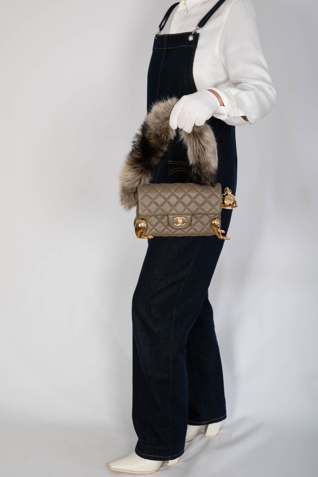 Chanel Squirrel Mini Flap Bag held by fur tail handle on model