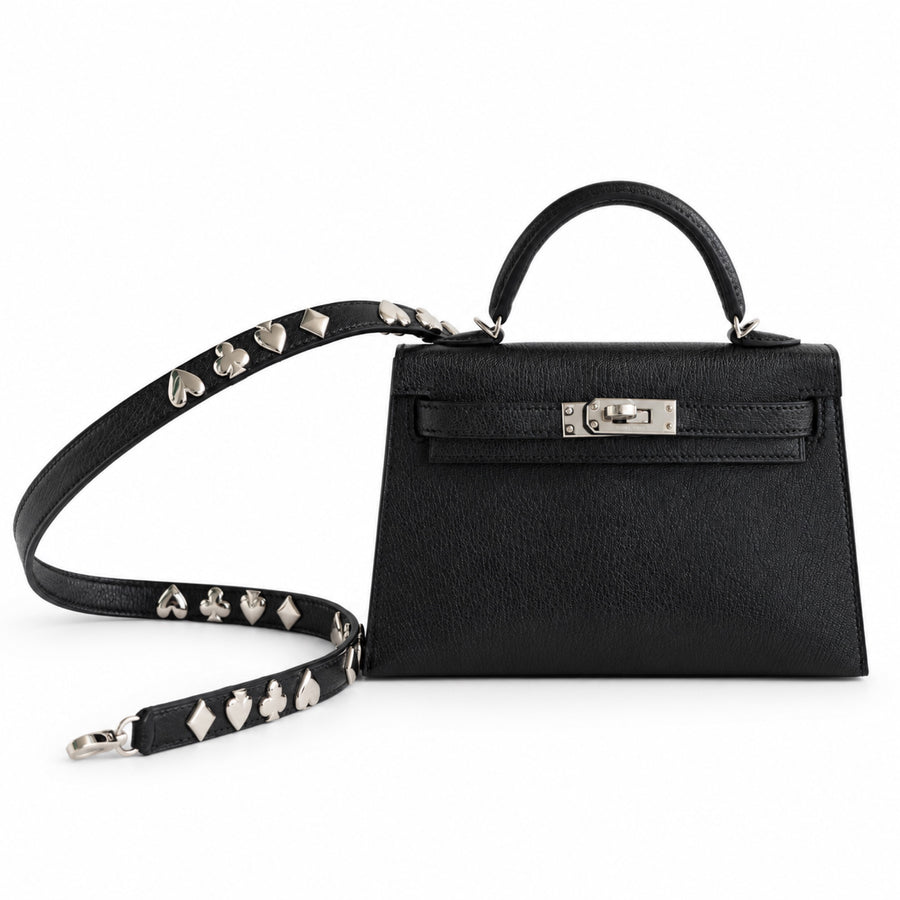 Hermès Clou de Coeur Kelly 20 Mini II Sellier Noir Chèvre Chamkila Palladium Hardware, front view with the studded strap laid out