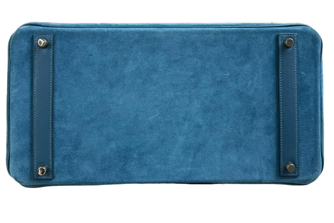 Blue handbag with gold accents on a white background