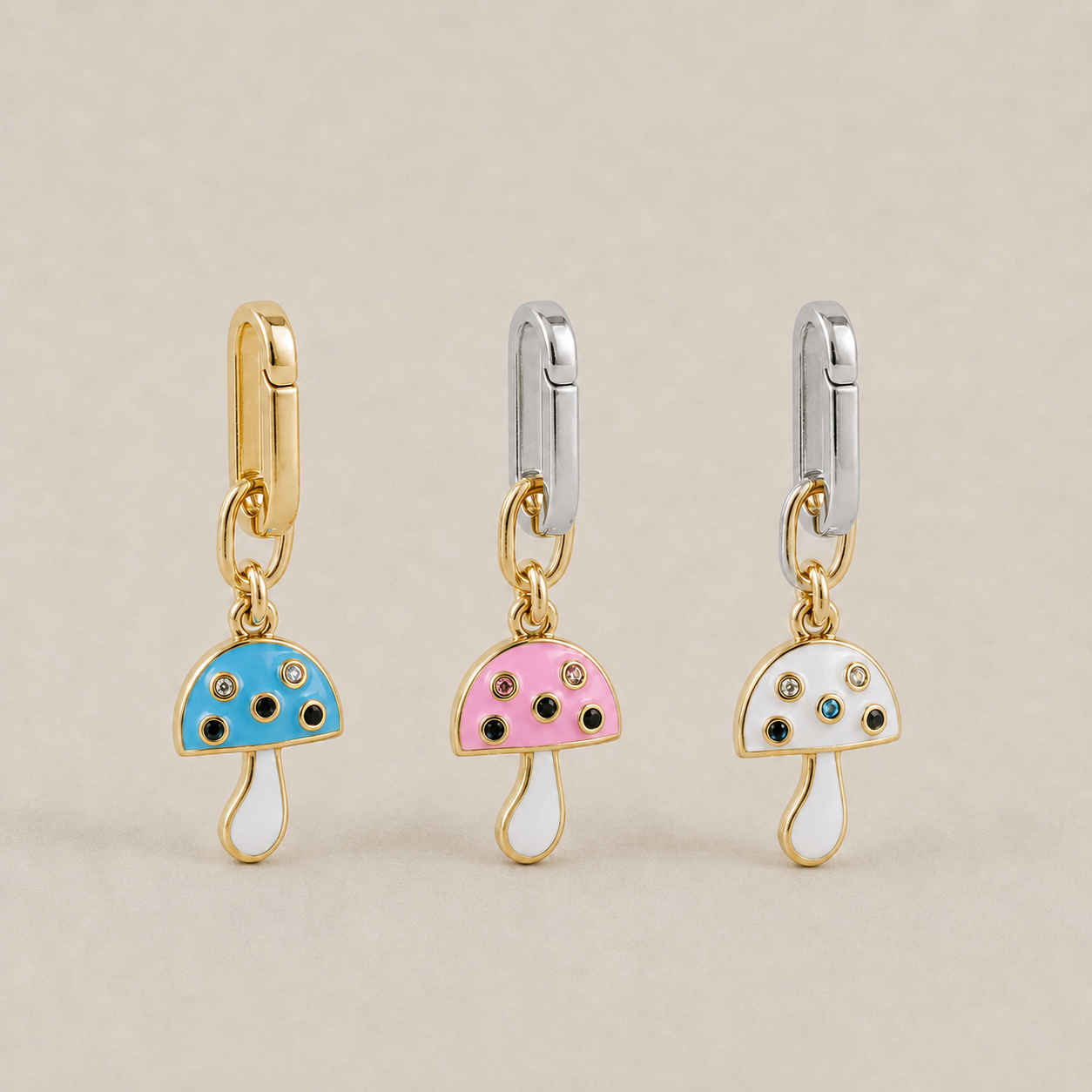 JaneFinds Lucky Shroom charms in blue, pink, and white on a warm neutral studio background