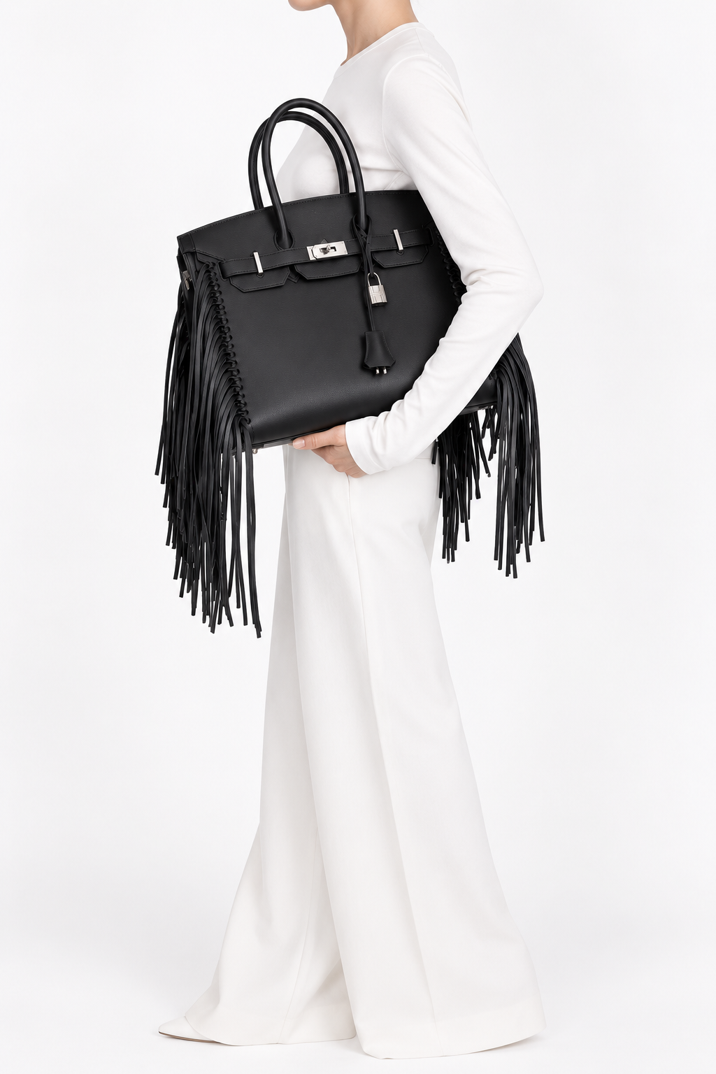 Hermès Birkin 35 Sellier Anate Fringe Noir Evercolor Palladium Hardware, model side-carry view in a white studio outfit