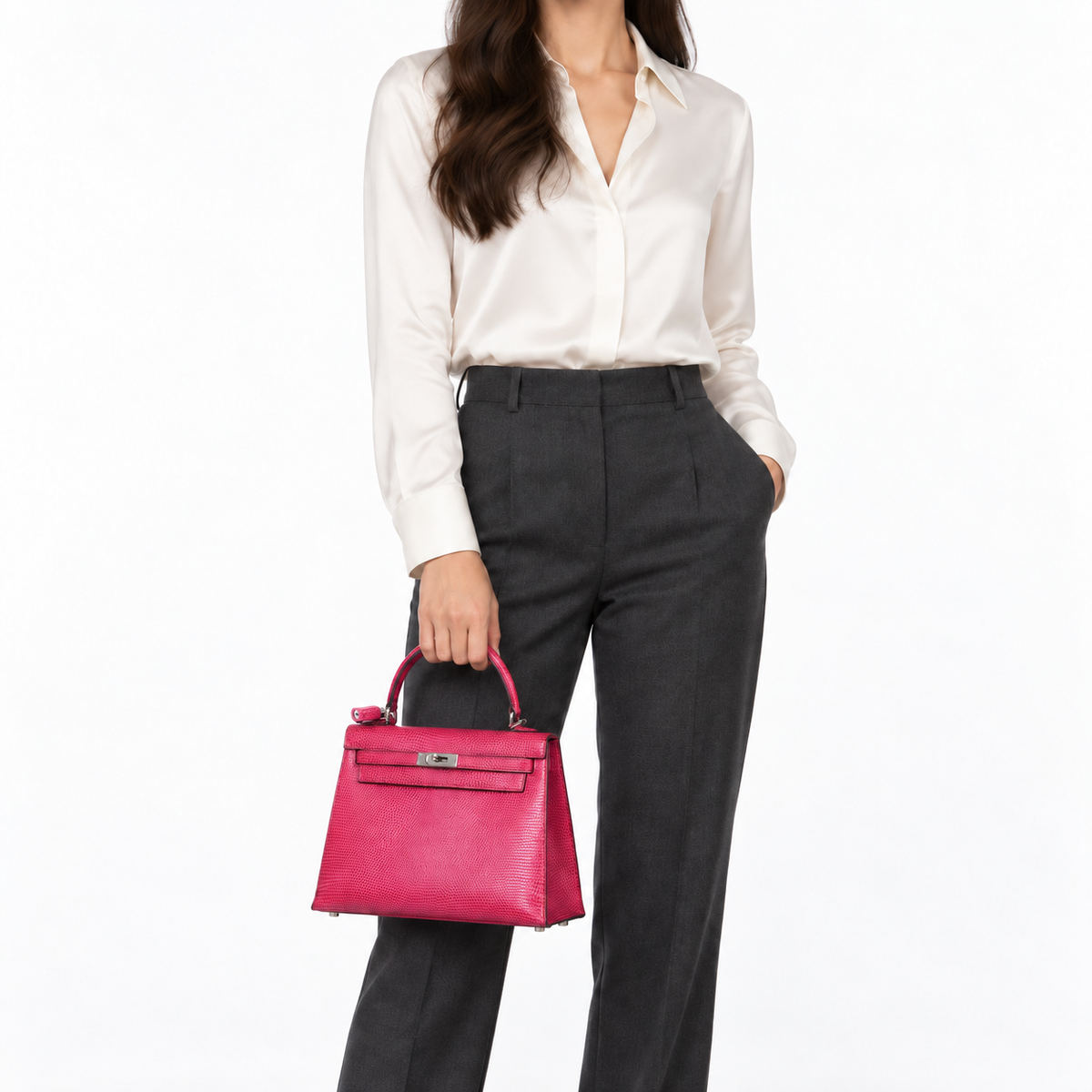 Hermès Kelly 25 Sellier in Fuchsia lizard with palladium hardware, carried by hand on a human model
