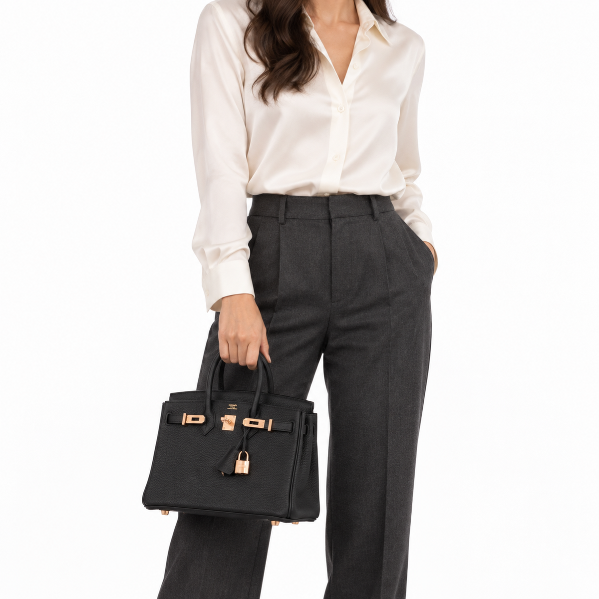 Hermès Birkin 25 Noir Togo with rose gold hardware, carried by hand on a human model