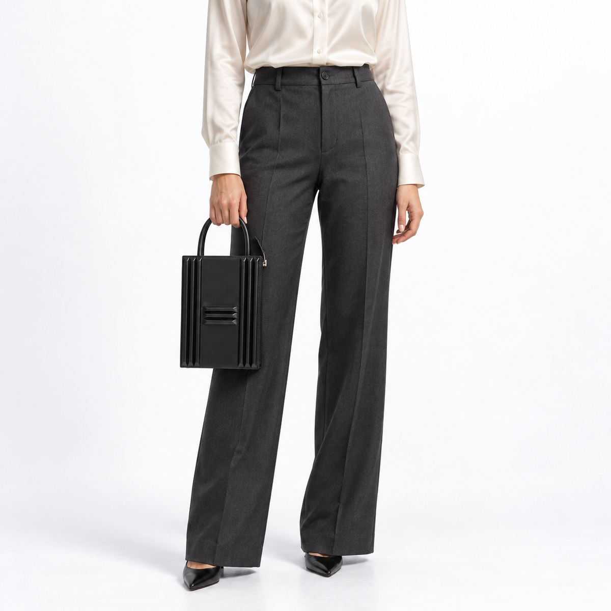 Hermès Cadena Lock Bag in black Tadelakt with palladium hardware, front hand-carry studio view on a model