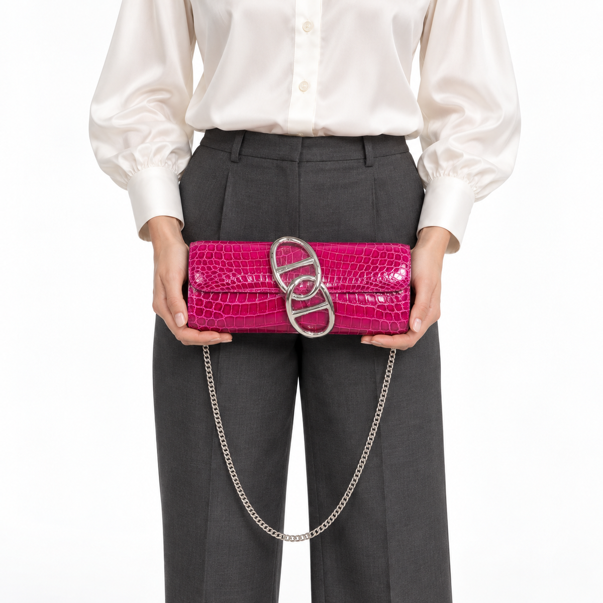 Hermès Egée clutch in Rose Scheherazade shiny Niloticus crocodile with palladium hardware, front hand-carry studio model view with silver chain