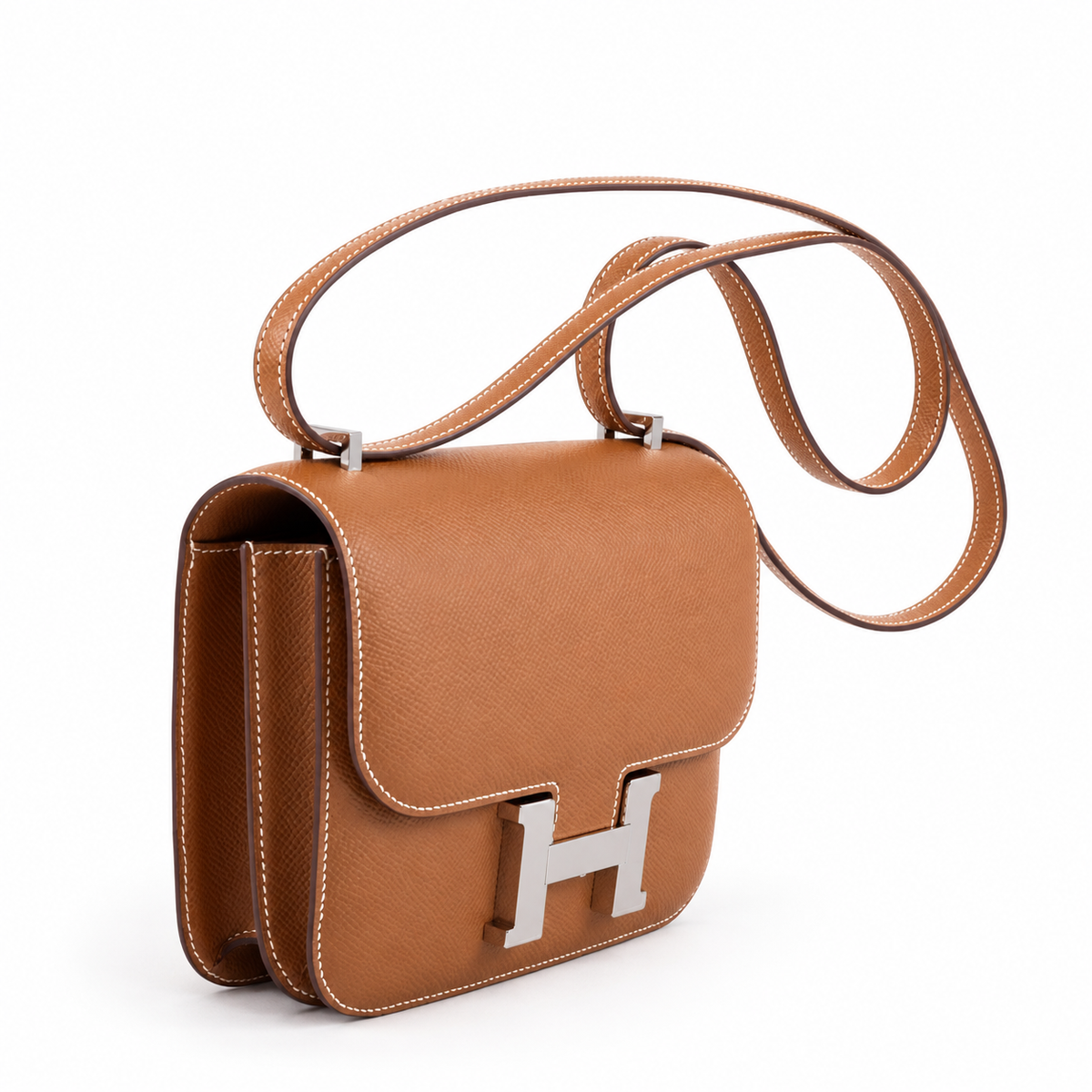 Hermès Constance 18 Mini III in Gold Epsom with palladium hardware, left three-quarter product view on white with a soft contact shadow.