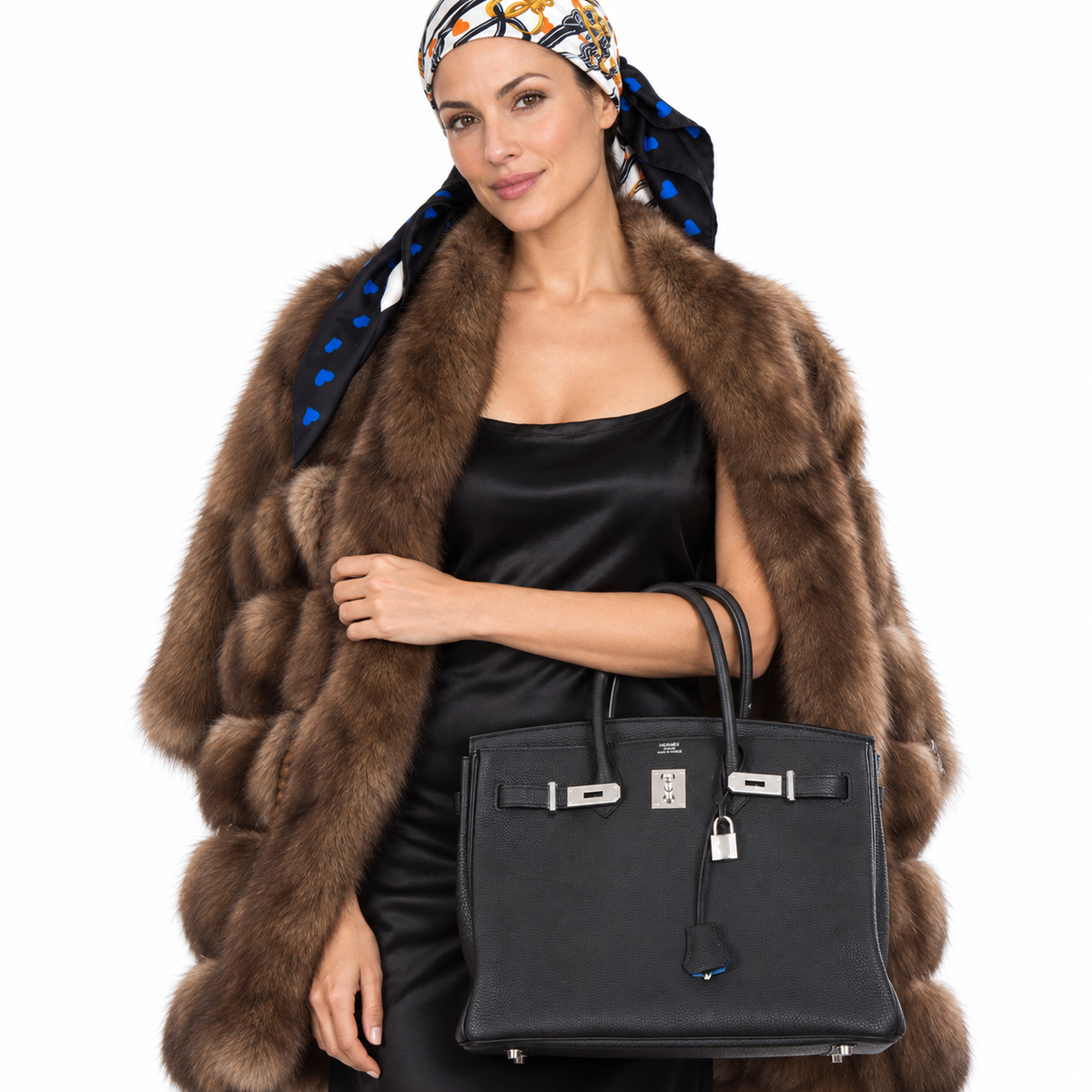 Hermès Birkin 35 Black Togo Verso Blue Agate Chevre Palladium Hardware carried by an adult model in a white studio