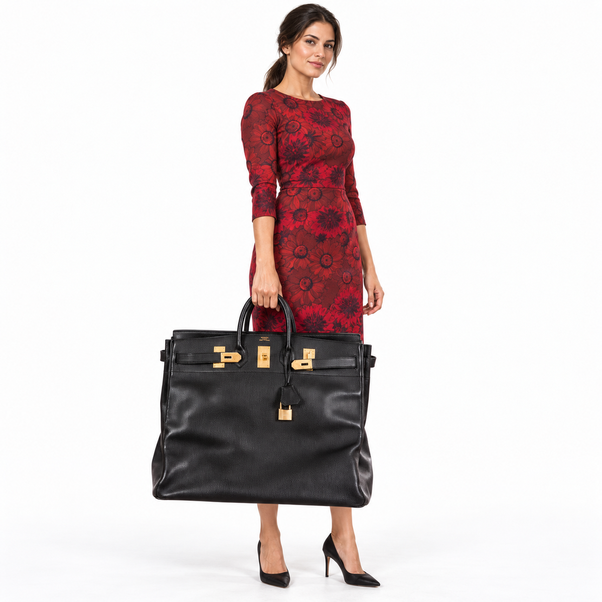 Hermès HAC 55 Black Ardennes Gold Hardware travel bag carried by a model in a white studio