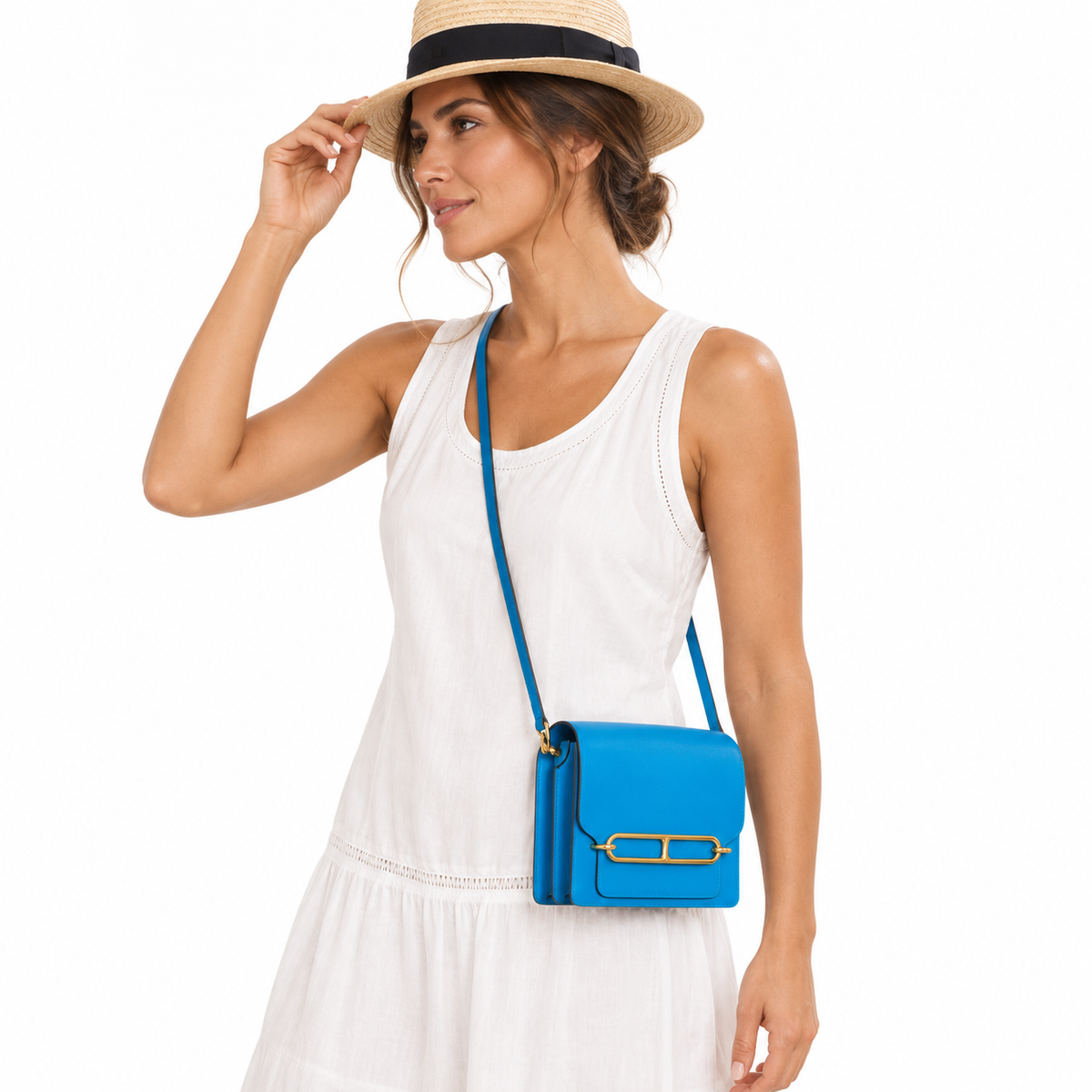 Hermès Roulis Mini Blue Zanzibar Gold Hardware worn crossbody by a woman in a white studio
