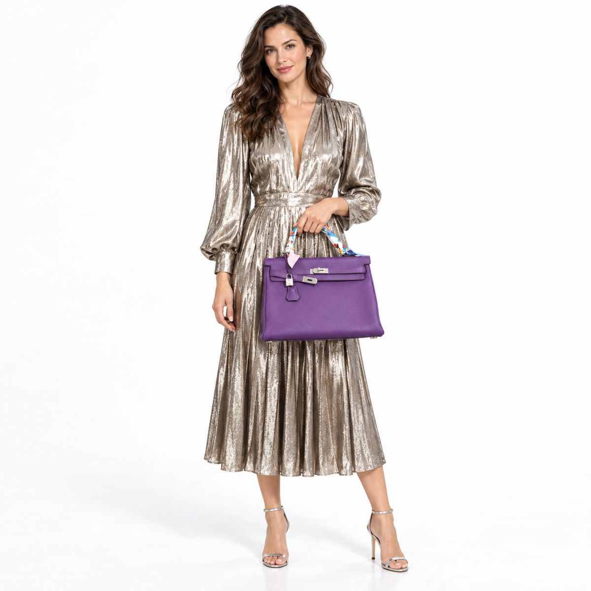 Hermès Kelly 35 Ultra Violet Clemence Palladium Hardware with wrapped handle carried by a model in a white studio