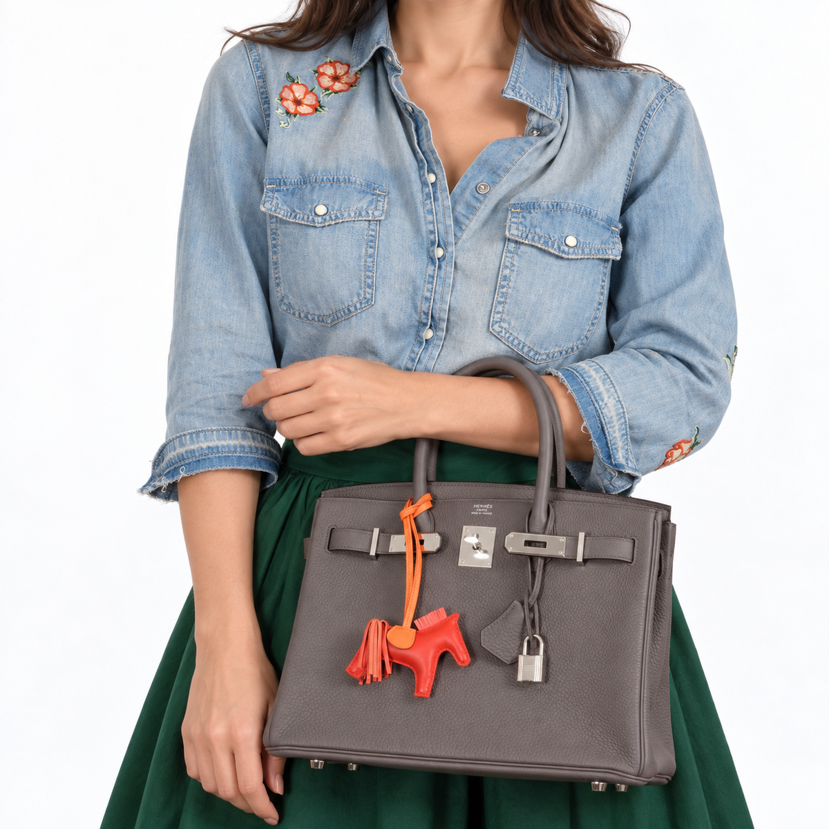 Hermès Birkin 30 Etain Togo with palladium hardware and Rodeo charm, human model forearm-carry detail.