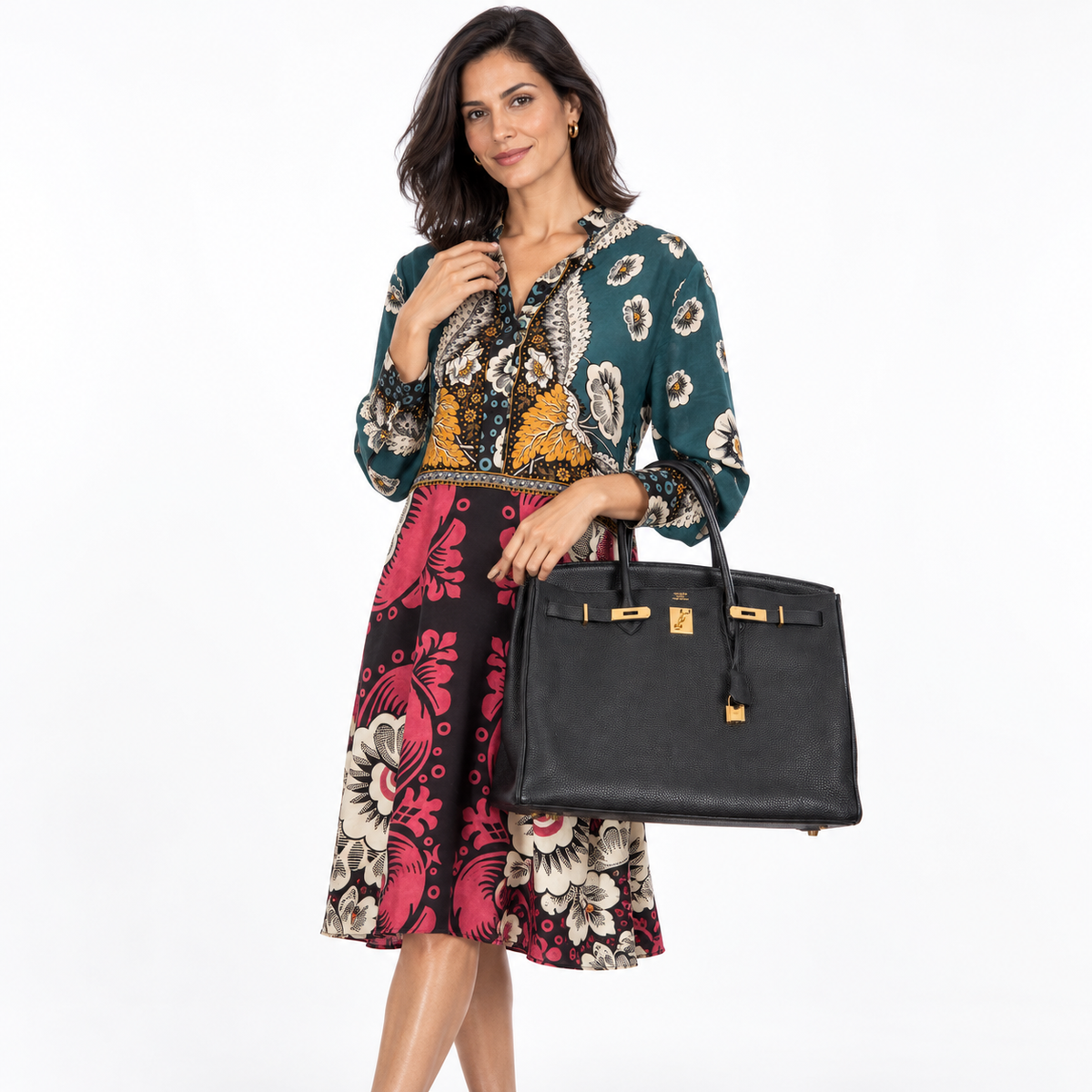 Hermès Birkin 40 Black Togo Gold Hardware carried by a woman in a white studio, full scale view
