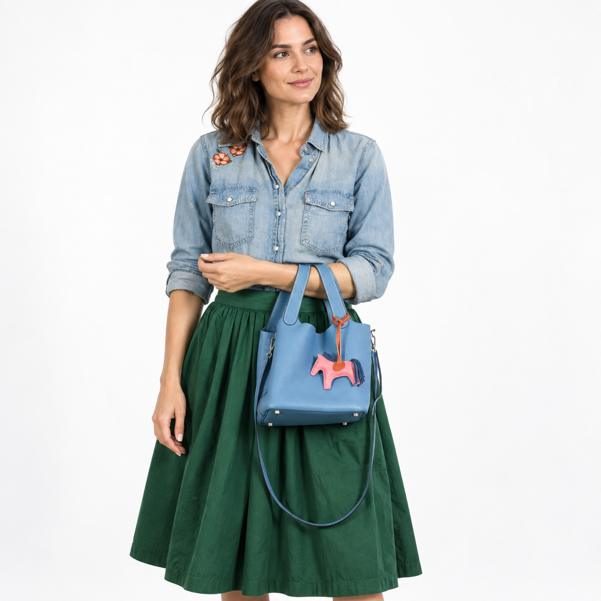 Hermès Picotin Lock PM Blue Jean Togo Palladium Hardware worn by a woman in a white studio