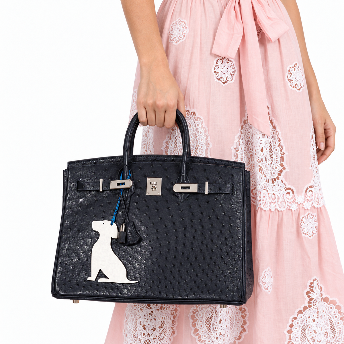 Hermès Birkin 35 Blue Indigo Ostrich Palladium Hardware carried by a human model on a white studio background.