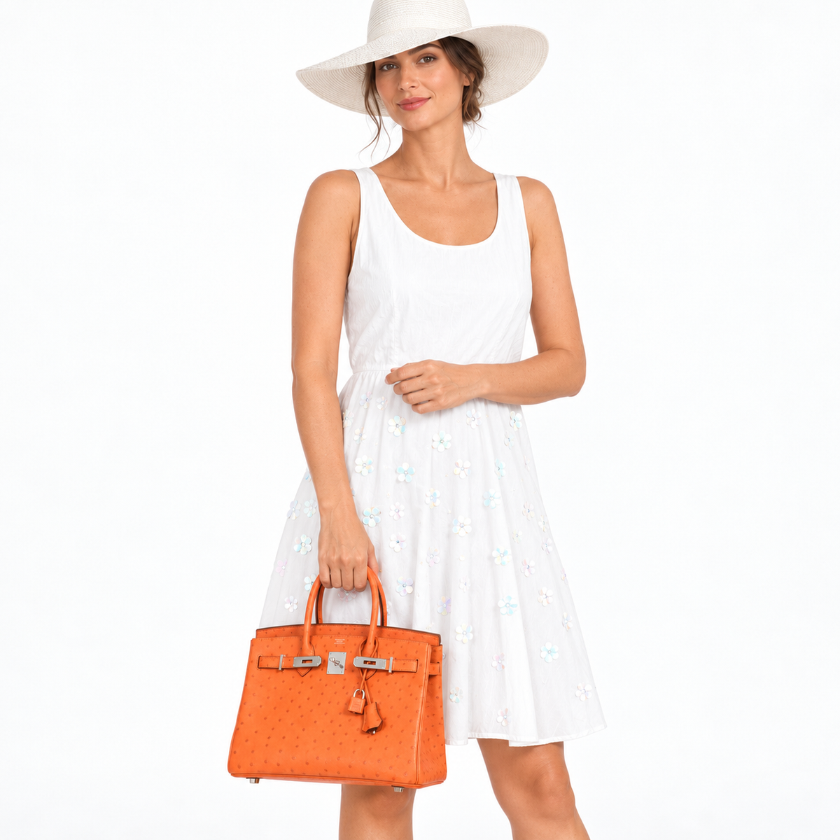 Hermès Birkin 30 Tangerine Ostrich with palladium hardware carried by a model