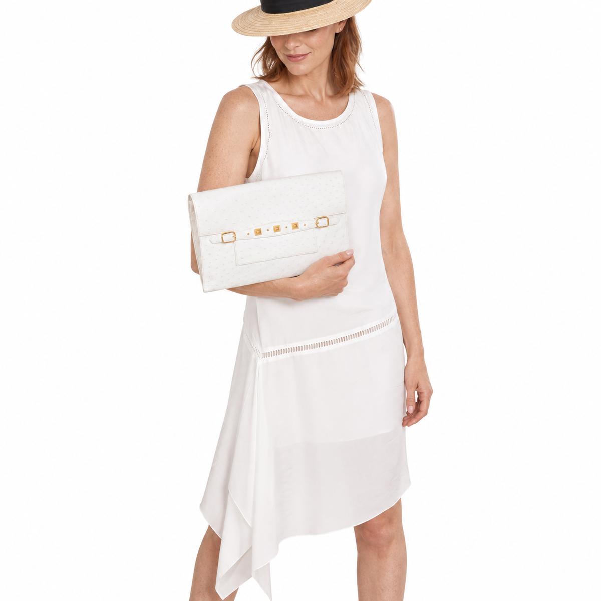 Hermès Pre-Medor Clutch White Ostrich with gold hardware held by a model