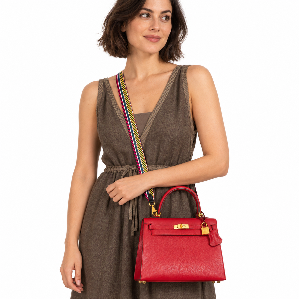Hermès Kelly 25 HSS Sellier Rouge Casaque Chevre Goat Brushed Gold Hardware - Special Order carried by a woman in a white studio