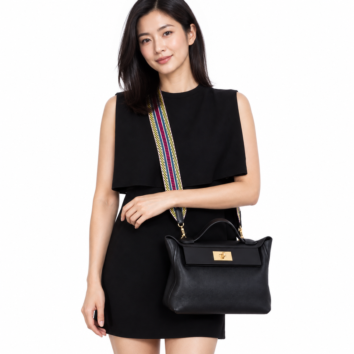 Hermès 24/24 29 Black Swift & Togo Gold Hardware carried by a woman in a white studio