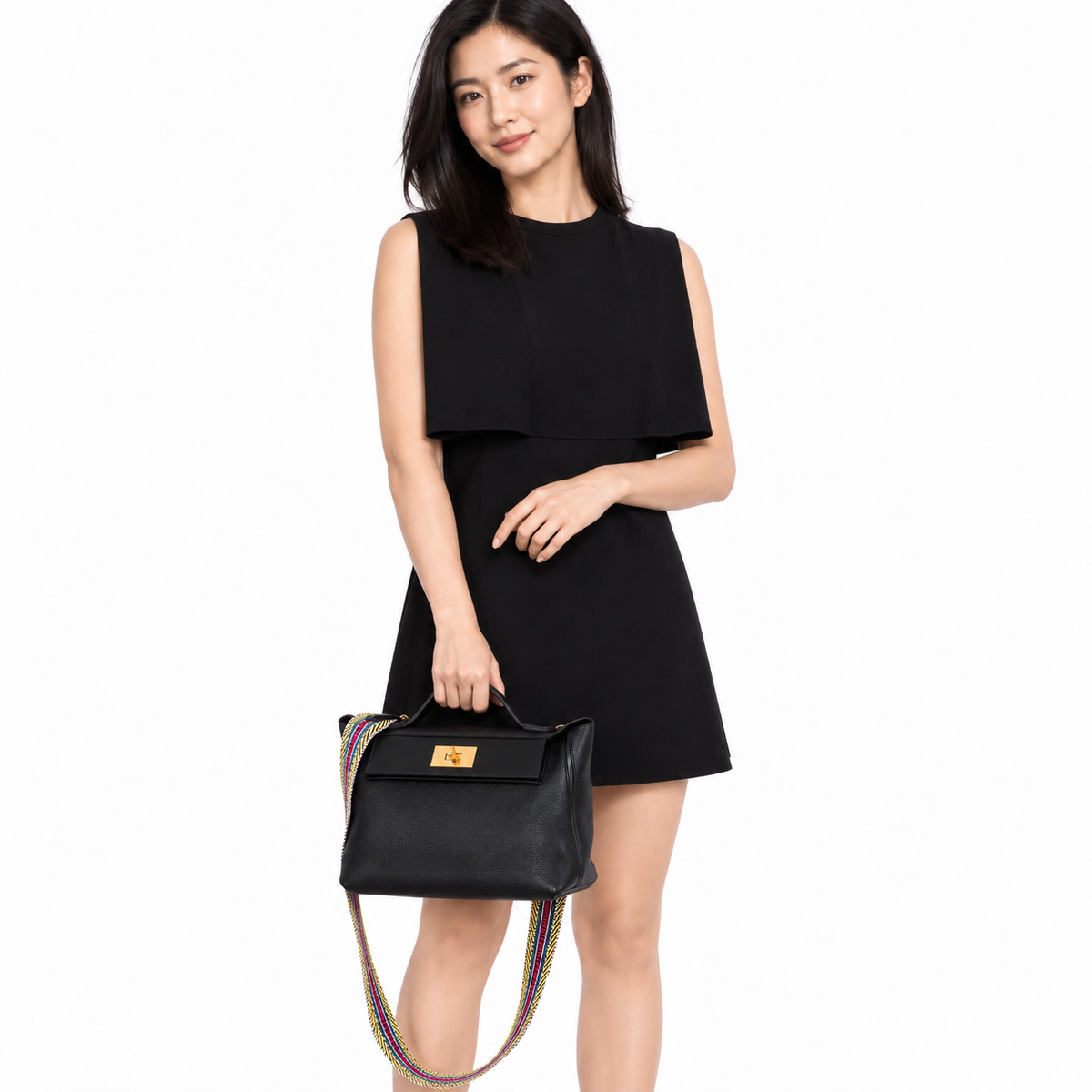 Hermès 24/24 29 Black Swift & Togo Gold Hardware carried by a woman in a white studio