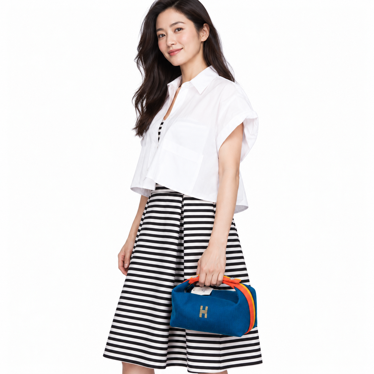 Hermès Bride-a-Brac Blue Paon Wool Rocabar PM Vanity Case shown on a model in a white studio.