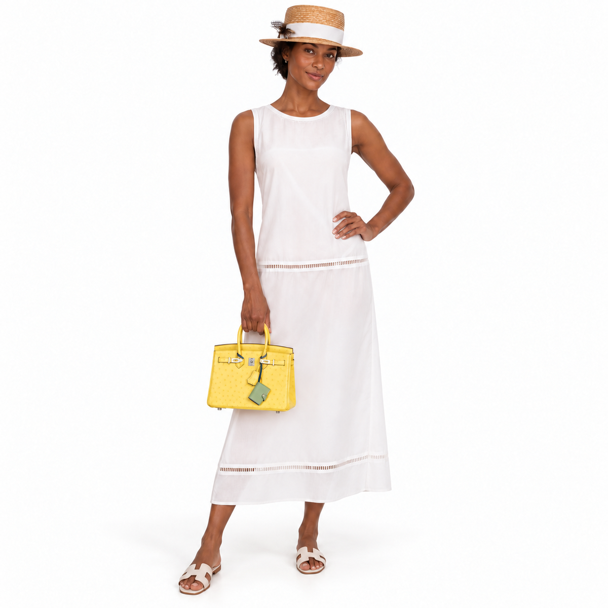 Hermès Birkin 25 Jaune Citron Ostrich Palladium Hardware on a model in a white studio
