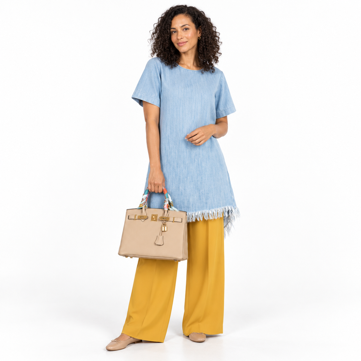 Hermès Birkin 30 Trench Togo Gold Hardware with twillies, carried by a model in a white studio
