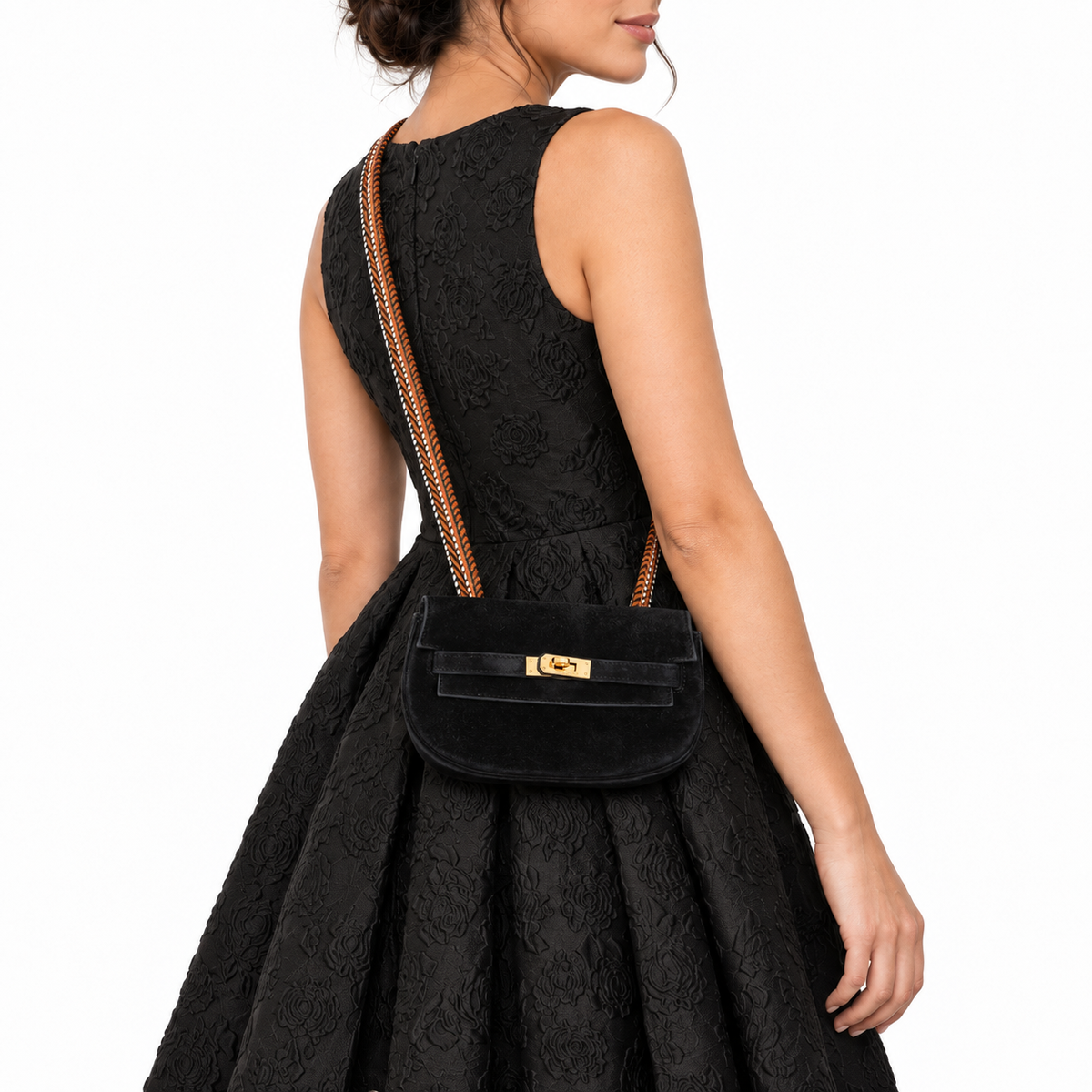 Hermès Kelly Banana 20 Black Suede Waist Pochette Gold Hardware worn by an adult model in a white studio, close detail