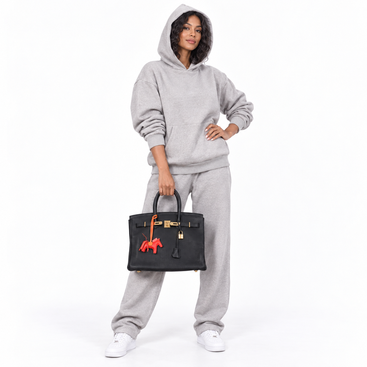 Hermès Birkin 35 Black Clemence Leather Gold Hardware - Square N shown on a model in a white studio.