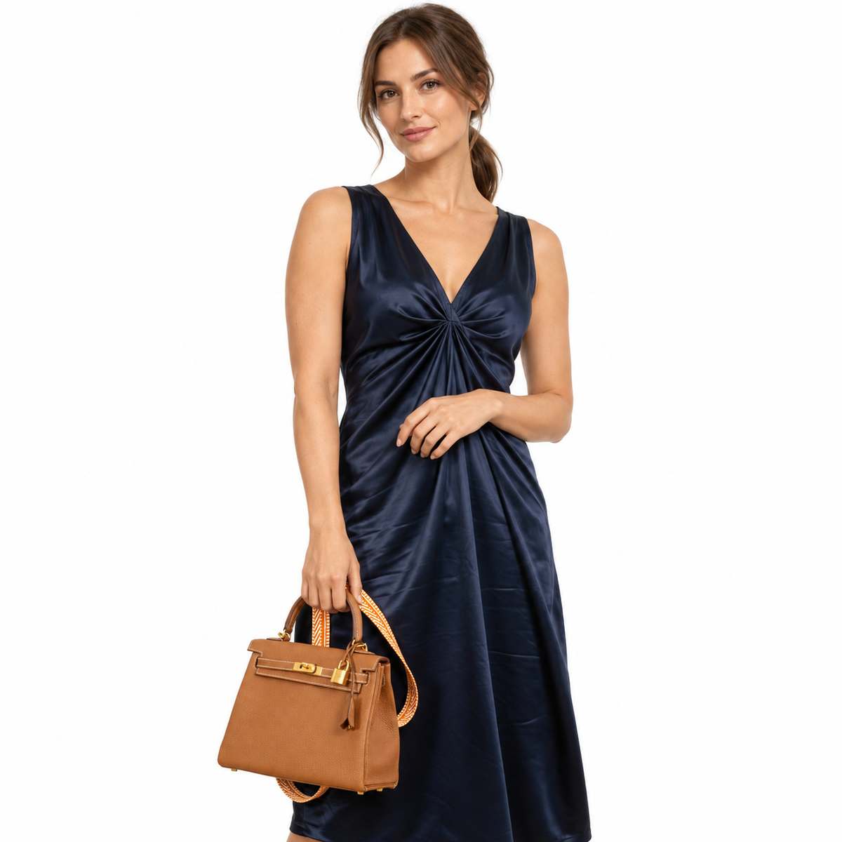 Hermès Kelly 25 Retourne Gold Togo Gold Hardware - 2019, D carried by a model in a white studio