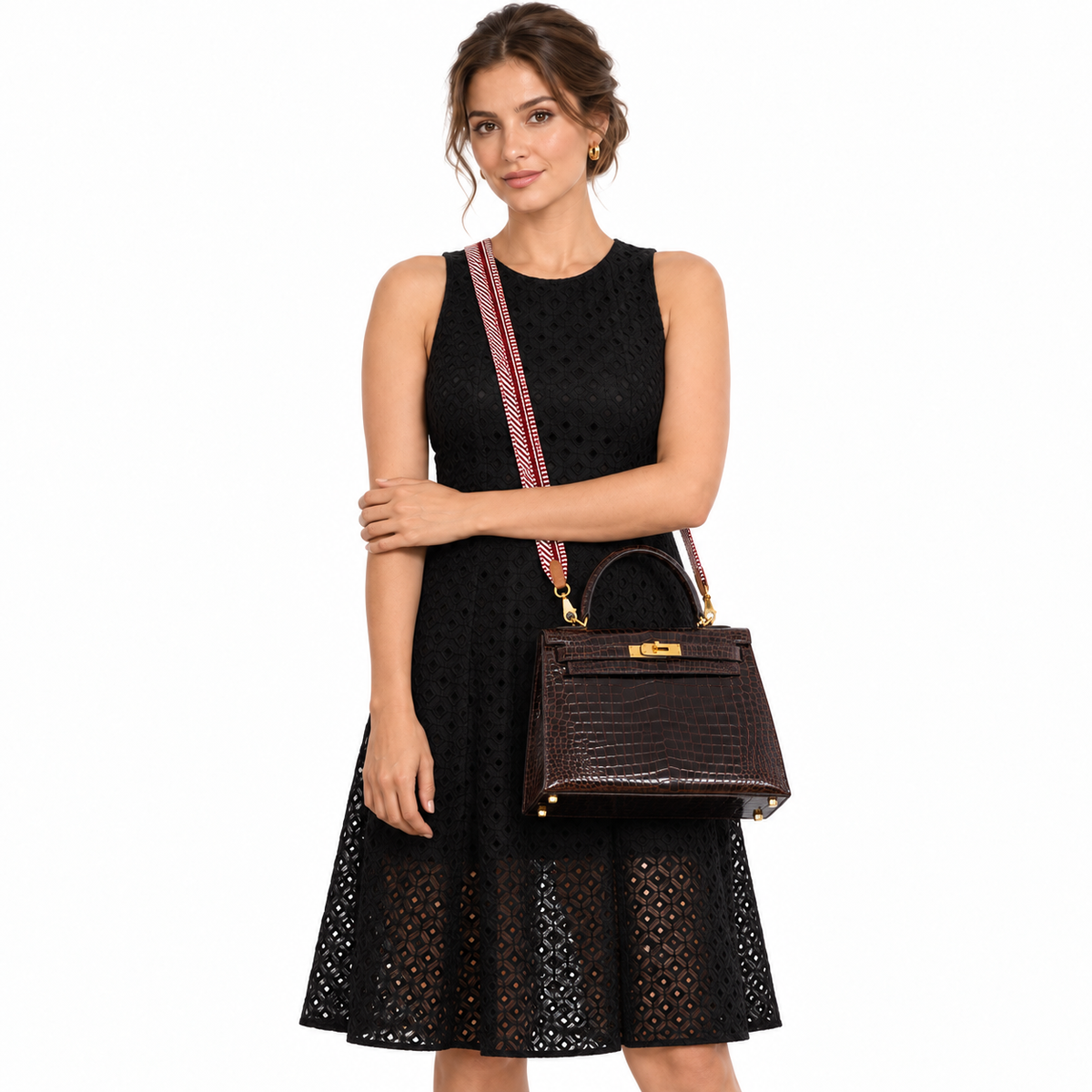 Hermès Kelly 28 Sellier Marron Foncé Shiny Porosus Crocodile Gold Hardware carried by a model in a white studio
