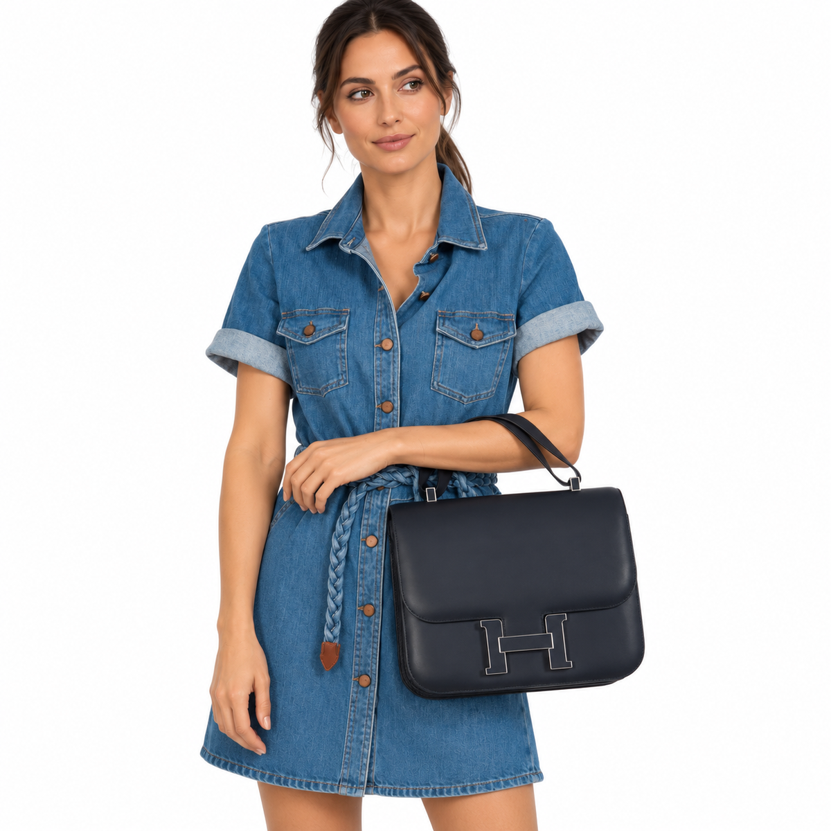 Hermès Constance 29 Cartable Bleu Obscur Veau Sombrero Palladium Hardware carried by a model in a white studio