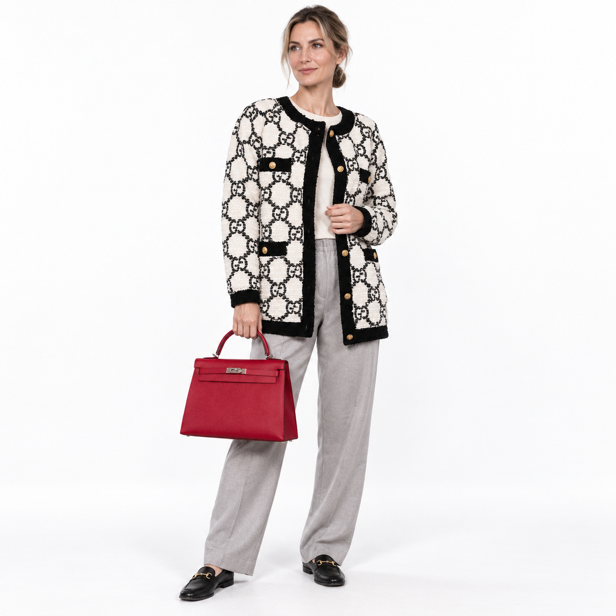 Hermès Kelly 32 Rouge Vif Epsom with palladium hardware carried by a human model in a white studio