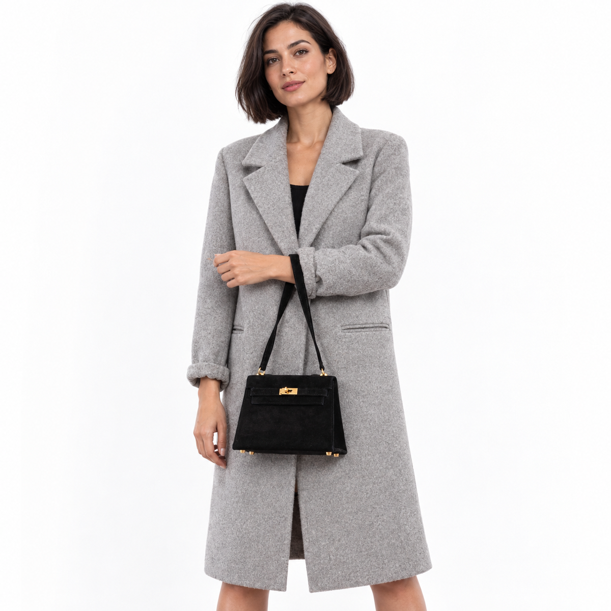 Hermès Kelly 20 Mini Sellier Shoulder Black Veau Doblis Suede Gold Hardware - 1999 carried by a model in a white studio