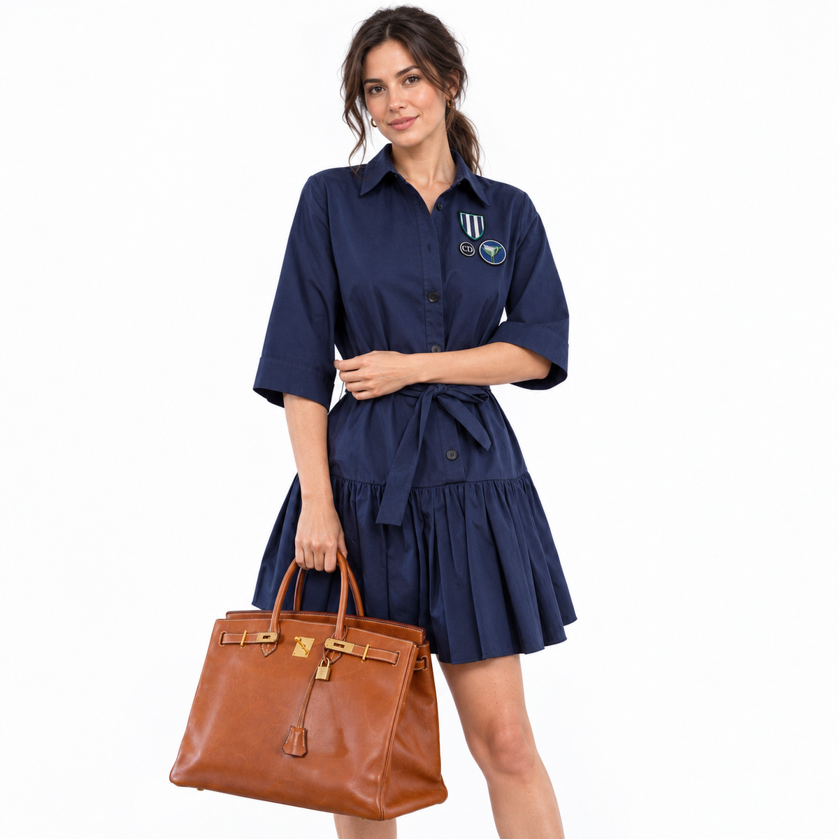 Hermès Birkin 40 Fauve Barenia Leather Gold Hardware carried by a model in a white studio
