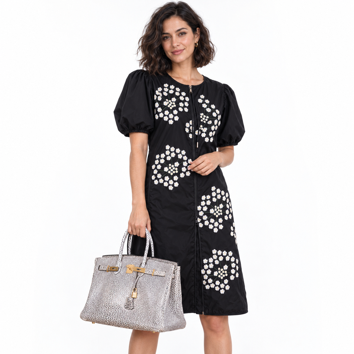 Hermès Birkin 35 Black & White Dalmatian Buffalo Gold Hardware carried by a model in a white studio