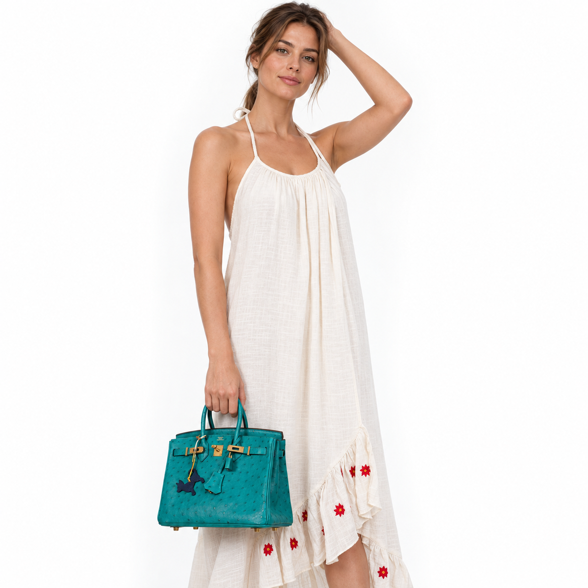 Hermès Birkin 25 Vert Verone Ostrich Gold Hardware carried by a model in a white studio