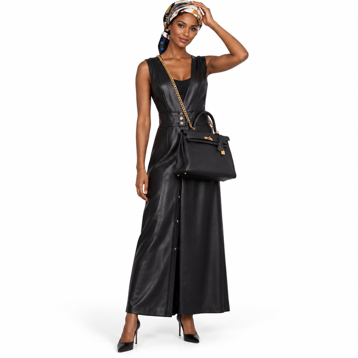 Hermès Kelly 35 Retourne Black Togo Gold Hardware worn by a model in a white studio