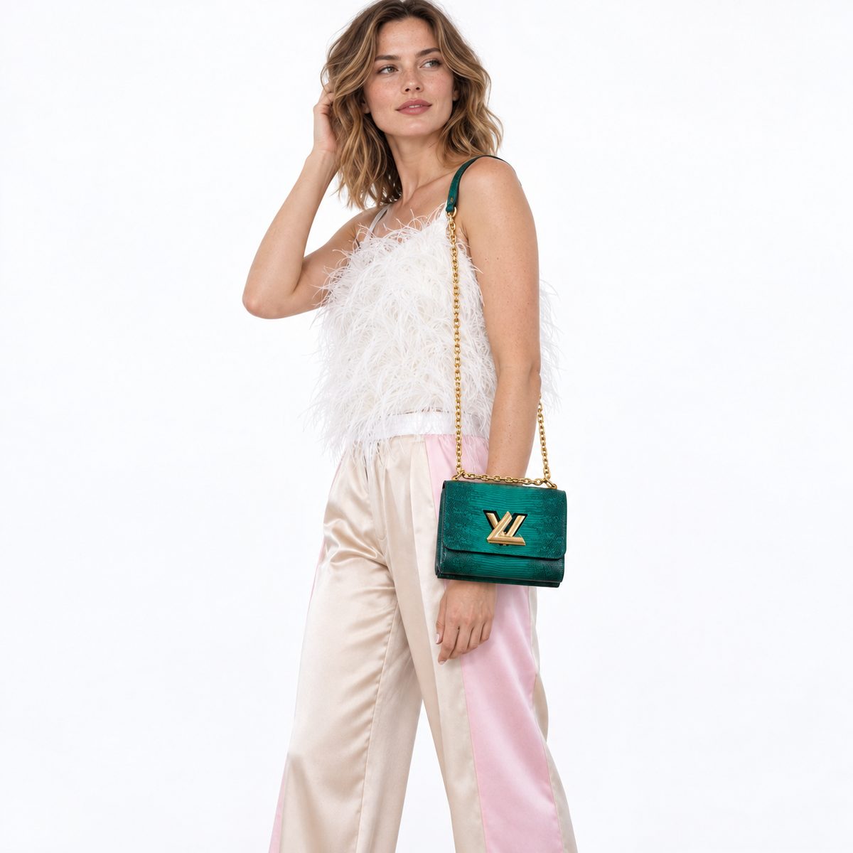 Louis Vuitton Twist PM Vert Emerald Ombre lizard gold hardware worn by a model on white