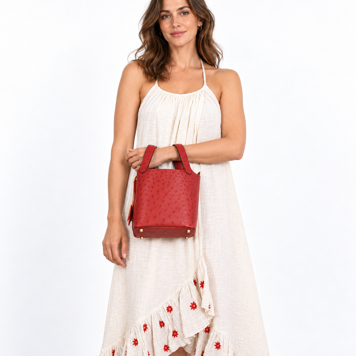 Hermès Picotin Lock 18 Rouge Vif Ostrich Tote Gold Hardware shown on a model in a white studio, wrist carry