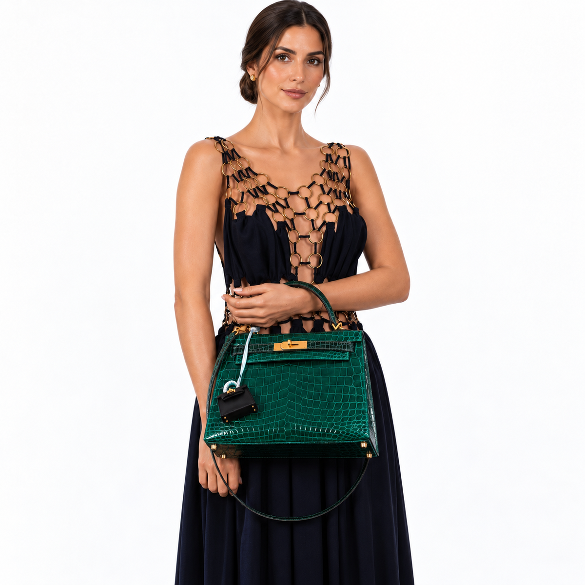 Hermès Kelly 28 Sellier HSS Emerald & Vert Fonce Nilo Crocodile Brushed Gold Hardware shown on a model in a white studio, wrist carry