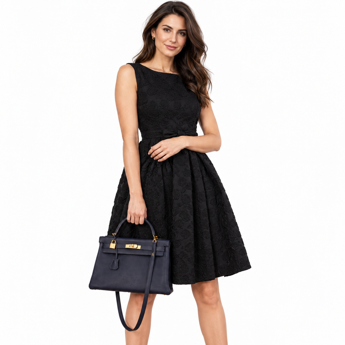 Hermès Kelly 32 Retourne Blue Indigo Togo Gold Hardware on an adult model in a white studio
