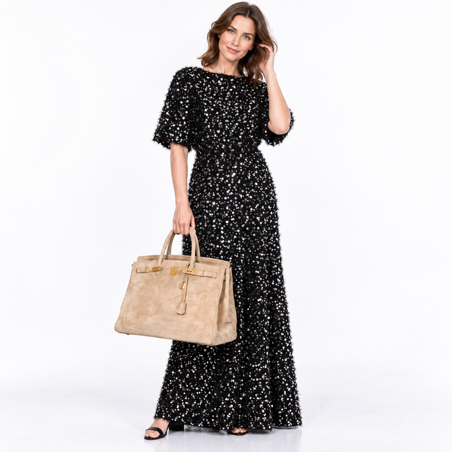 Hermès Birkin 40 beige Veau Doblis suede with gold hardware carried by a human model in a white studio
