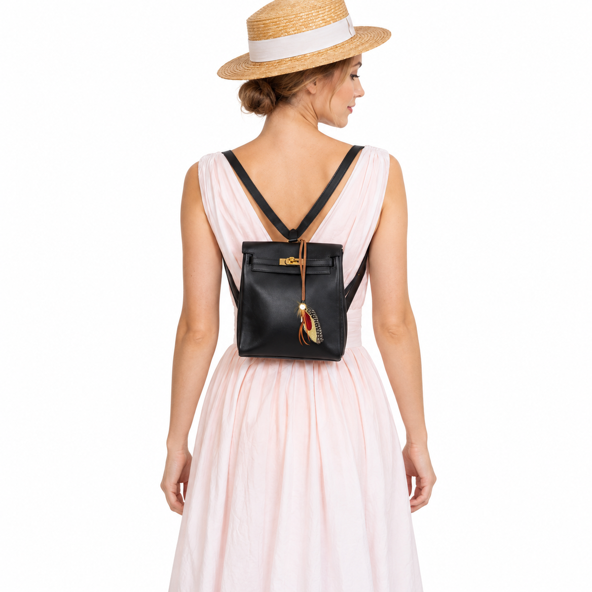 Hermès Mini Kelly Ado 20 Black Gulliver Gold Hardware worn by an adult human model on a white studio background