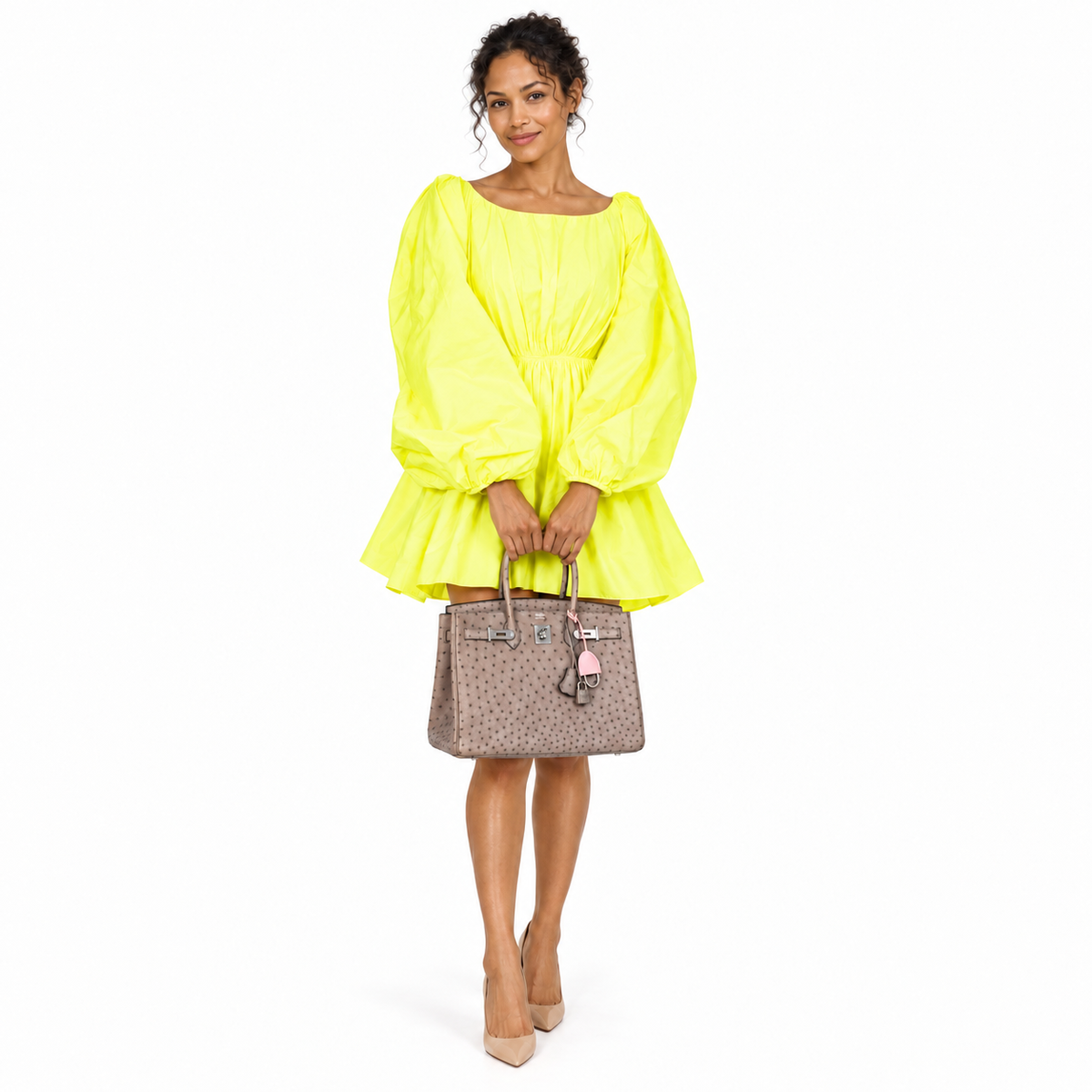 Hermès Birkin 35 Gris Tourterelle Ostrich Palladium Hardware worn by an adult human model on a white studio background