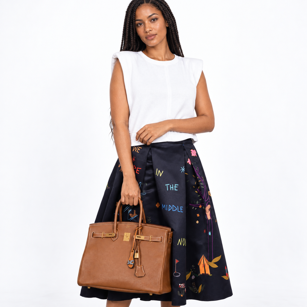 Hermès Birkin 35 Gold Togo gold hardware carried by a model on white