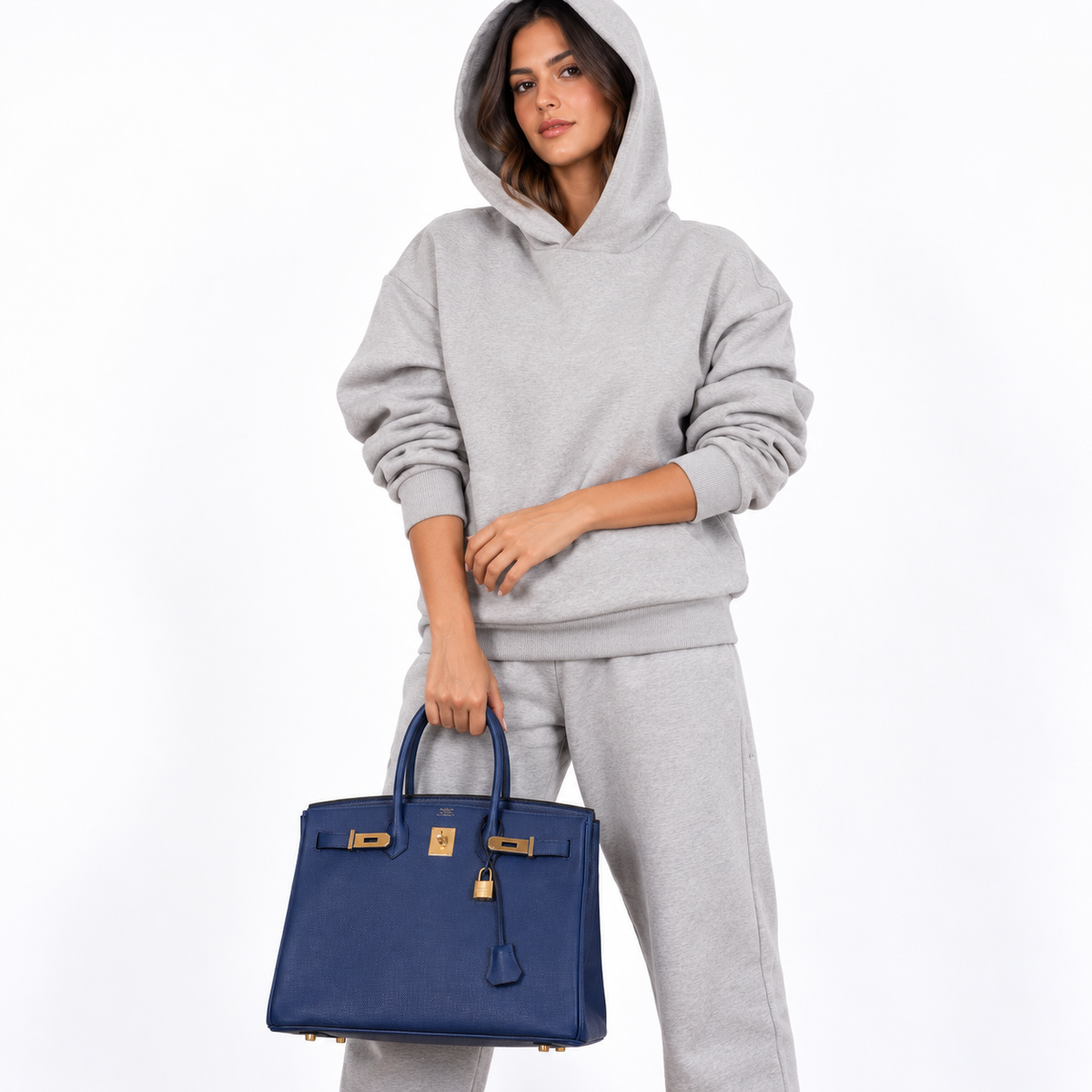 Hermès Birkin 35 Blue Saphire Epsom gold hardware carried by a model on white