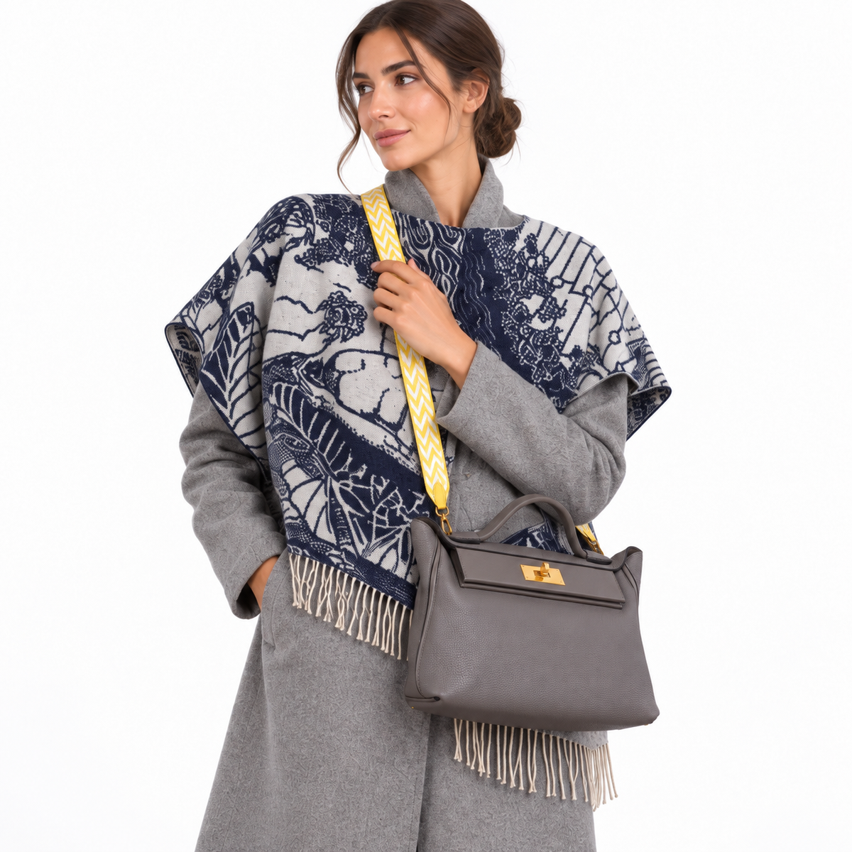 Hermès 24/24 29 Etain Togo and Swift gold hardware shoulder carry close view on a model in a white studio