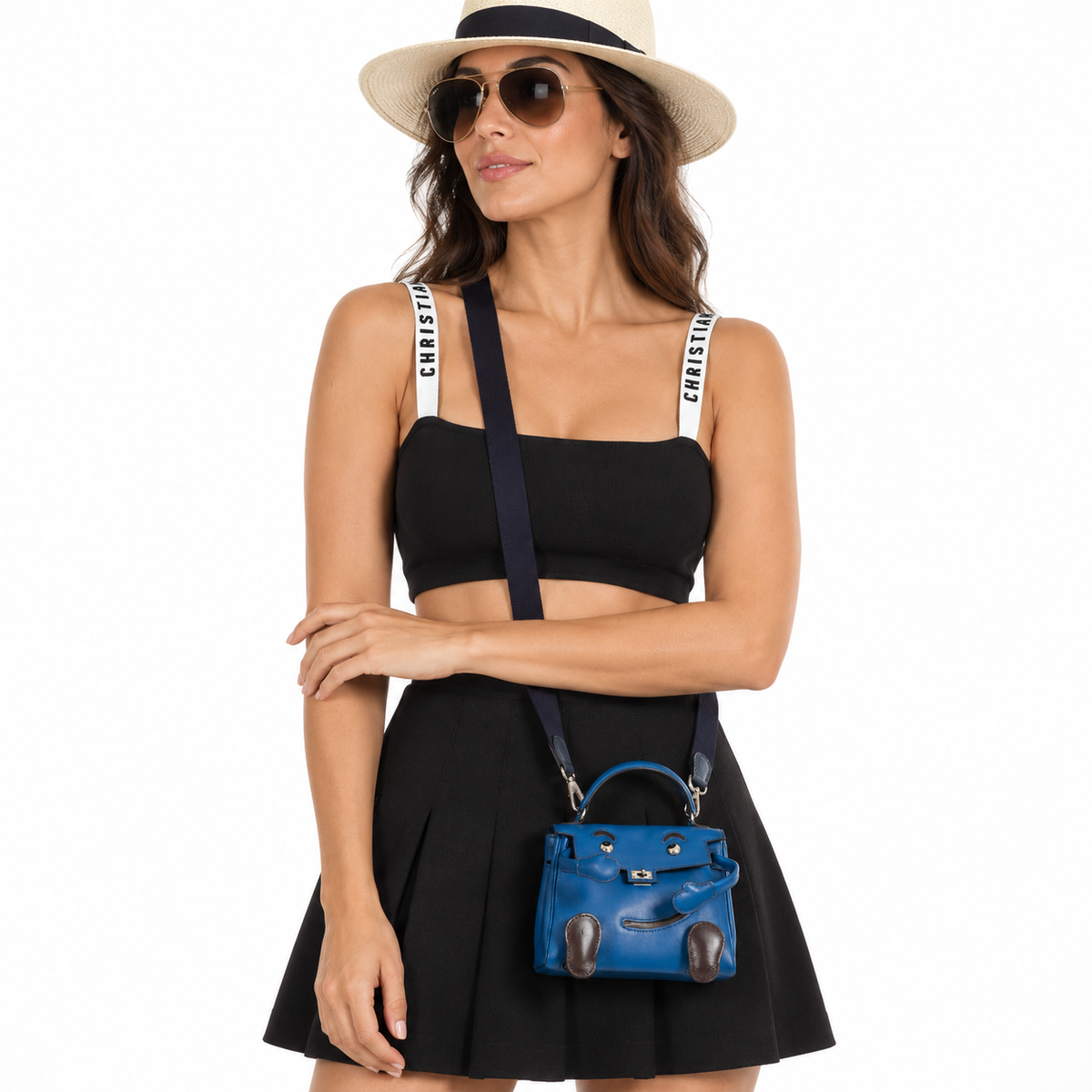 Hermès Kelly Quelle Idole doll bag in blue Gulliver leather worn by an adult model in a white studio