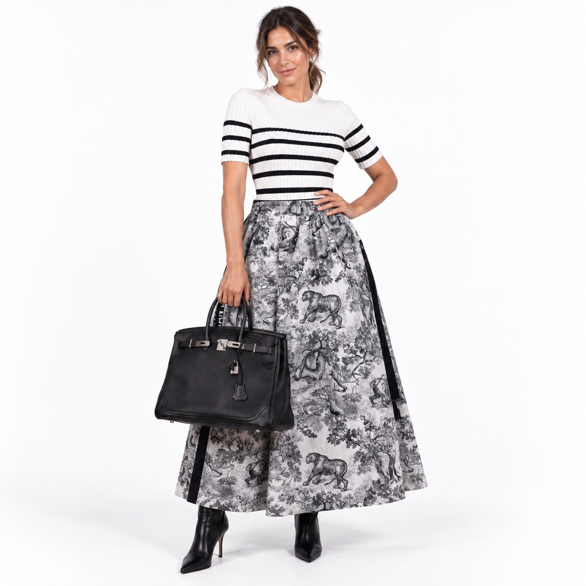 Hermès Ghillies Birkin 35 black Togo and Evergrain palladium hardware carried by a model in a white studio